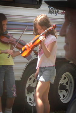 Comparing notes at a fiddle festival